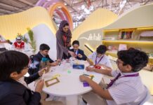 Children learn sustainability by making picture frames from waste materials at the 43rd Sharjah International Book Fair