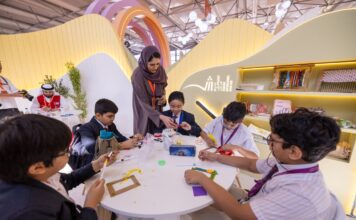 Children learn sustainability by making picture frames from waste materials at the 43rd Sharjah International Book Fair