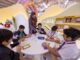 Children learn sustainability by making picture frames from waste materials at the 43rd Sharjah International Book Fair