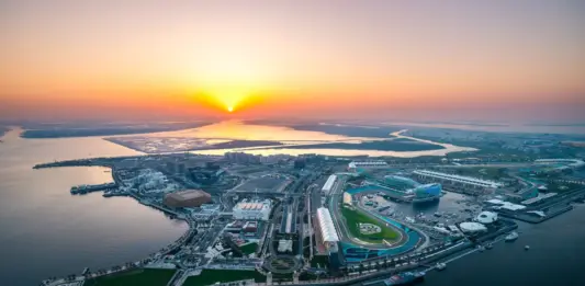 Miral and Etihad Rail plan Yas Island shuttle connections Aerial view of Yas Island and its waterfront at sunset.