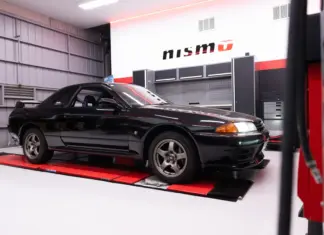 Nissan opens first overseas NISMO Performance Centre in Melbourne Black Nissan GT-R inside a NISMO-branded workshop.