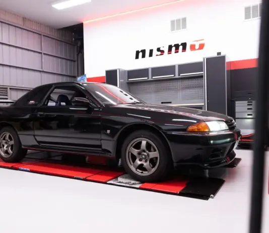 Nissan opens first overseas NISMO Performance Centre in Melbourne Black Nissan GT-R inside a NISMO-branded workshop.