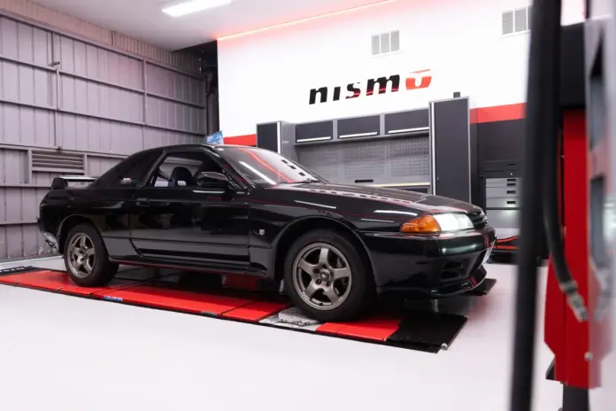 NISMO Performance Centre in Melbourne Black Nissan GT-R inside a NISMO-branded workshop.